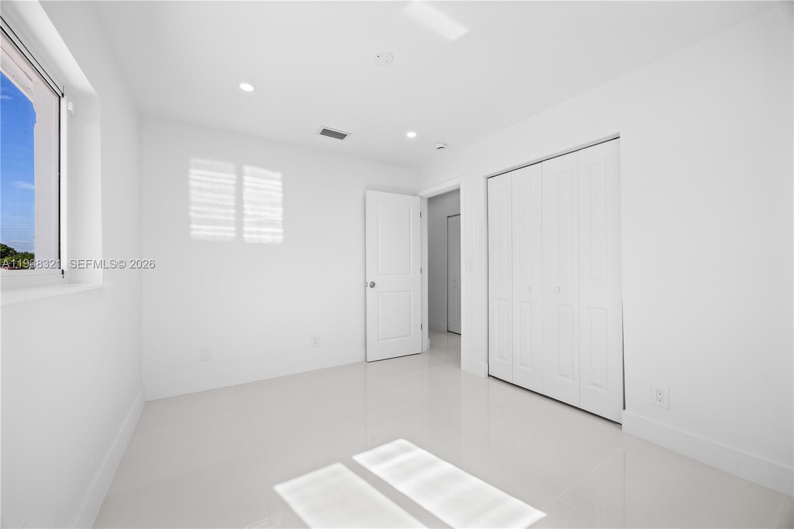 22503 Southwest 113th Place Miami, FL 33170 - Photo 8 of 35 a view of an empty room with a window