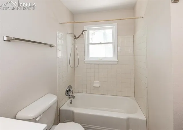 a bathroom with a toilet and a bathtub