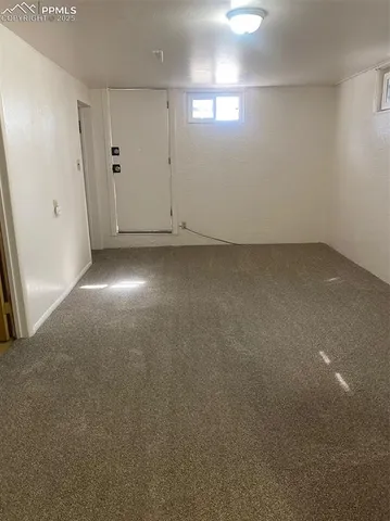 a view of an empty room with kitchen