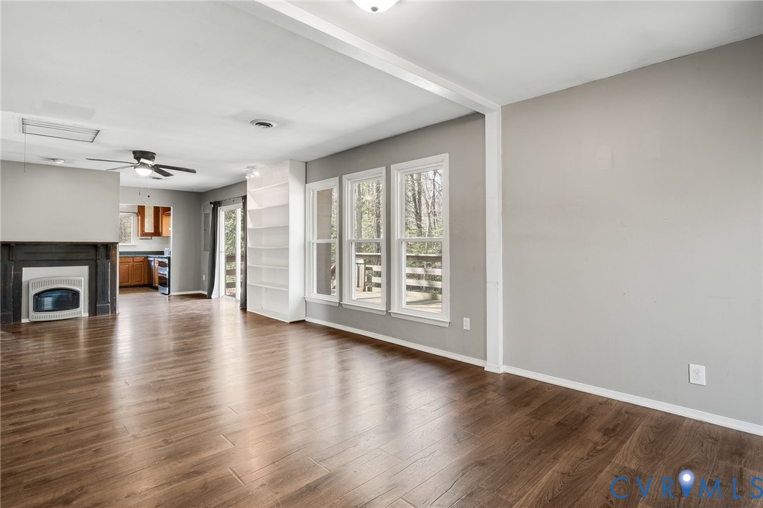 4740 West Grey Fox Circle Gum Spring, VA 23065 - Photo 11 of 21 a view of a livingroom with wooden floor and a fireplace