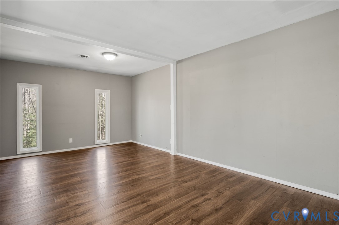 4740 West Grey Fox Circle Gum Spring, VA 23065 - Photo 12 of 21 a view of an empty room with wooden floor and a window