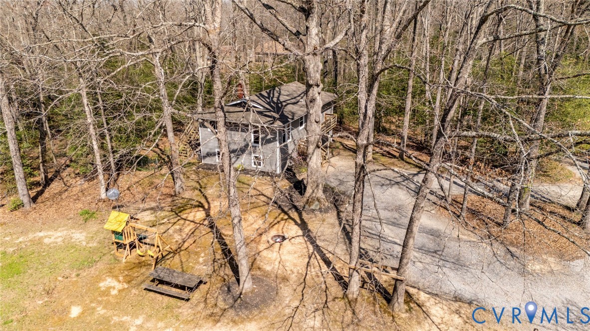 4740 West Grey Fox Circle Gum Spring, VA 23065 - Photo 16 of 21 a backyard of a house with lots of tree