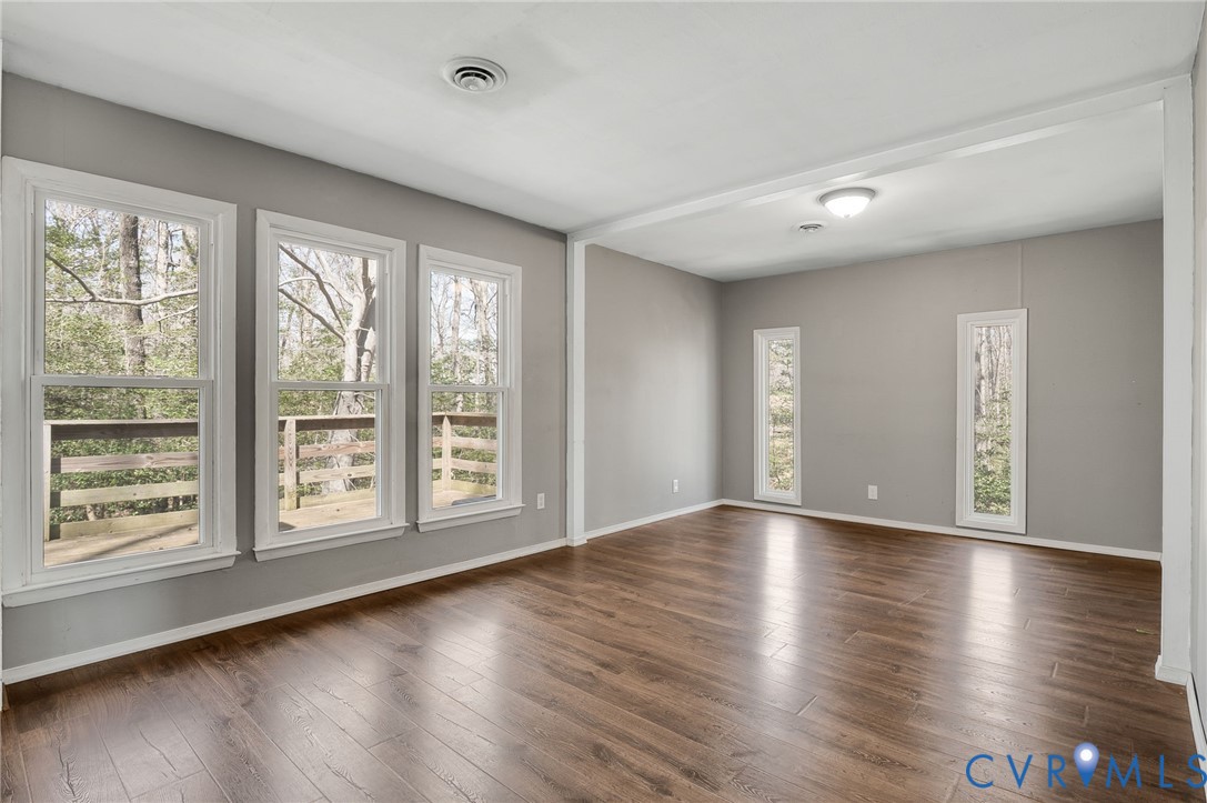 4740 West Grey Fox Circle Gum Spring, VA 23065 - Photo 9 of 21 a view of an empty room with wooden floor and a window