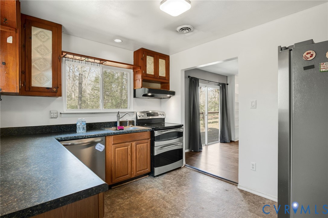 4740 West Grey Fox Circle Gum Spring, VA 23065 - Photo 10 of 21 a kitchen with stainless steel appliances granite countertop a sink and a refrigerator
