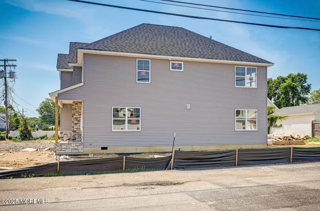 a front view of a house with a road