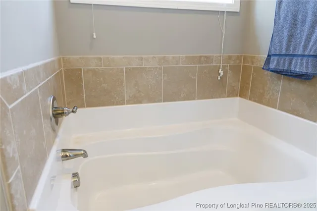 a bathroom with a shower and a bath tub