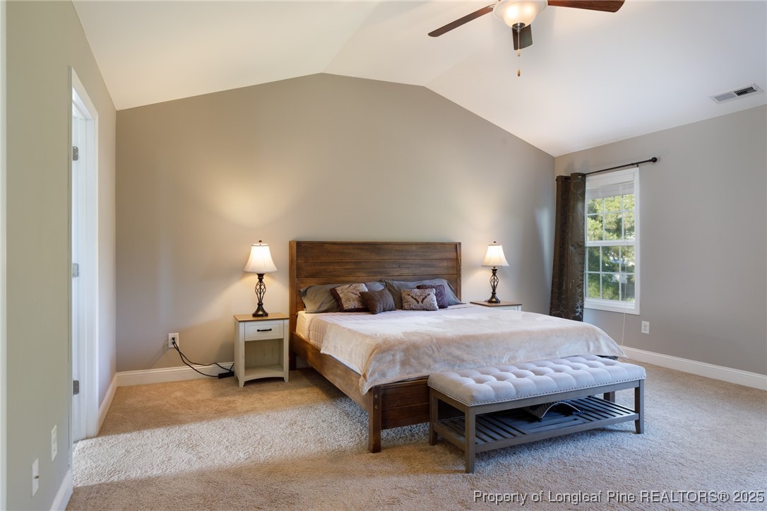 40 Cherry Hill Drive Lillington, NC 27546 - Photo 16 of 30 a bedroom with a bed and a lamp