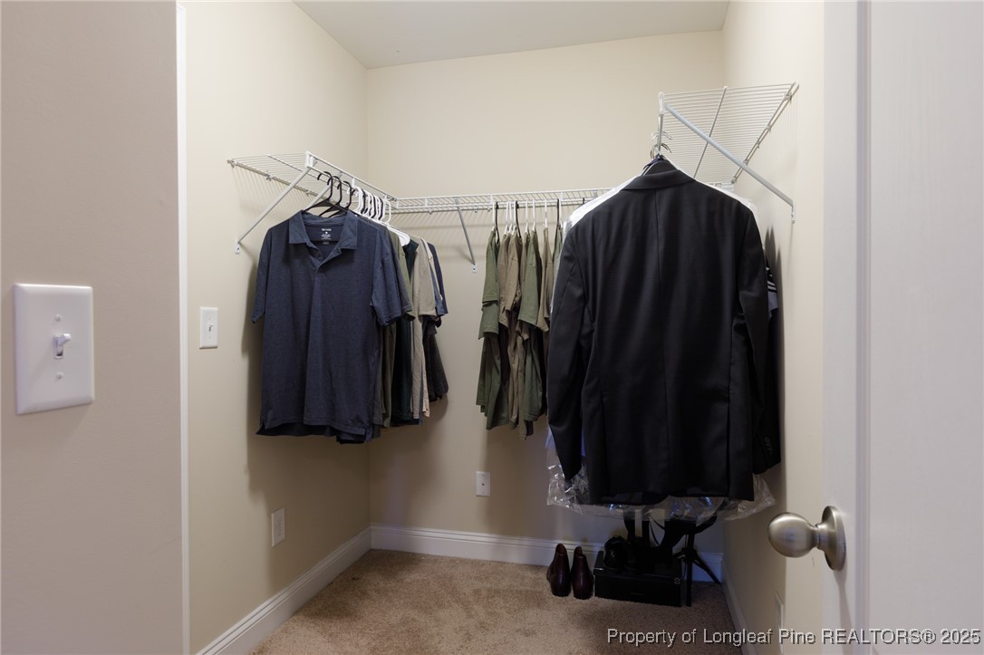 40 Cherry Hill Drive Lillington, NC 27546 - Photo 18 of 30 a view of walk in closet with clothes and shoes