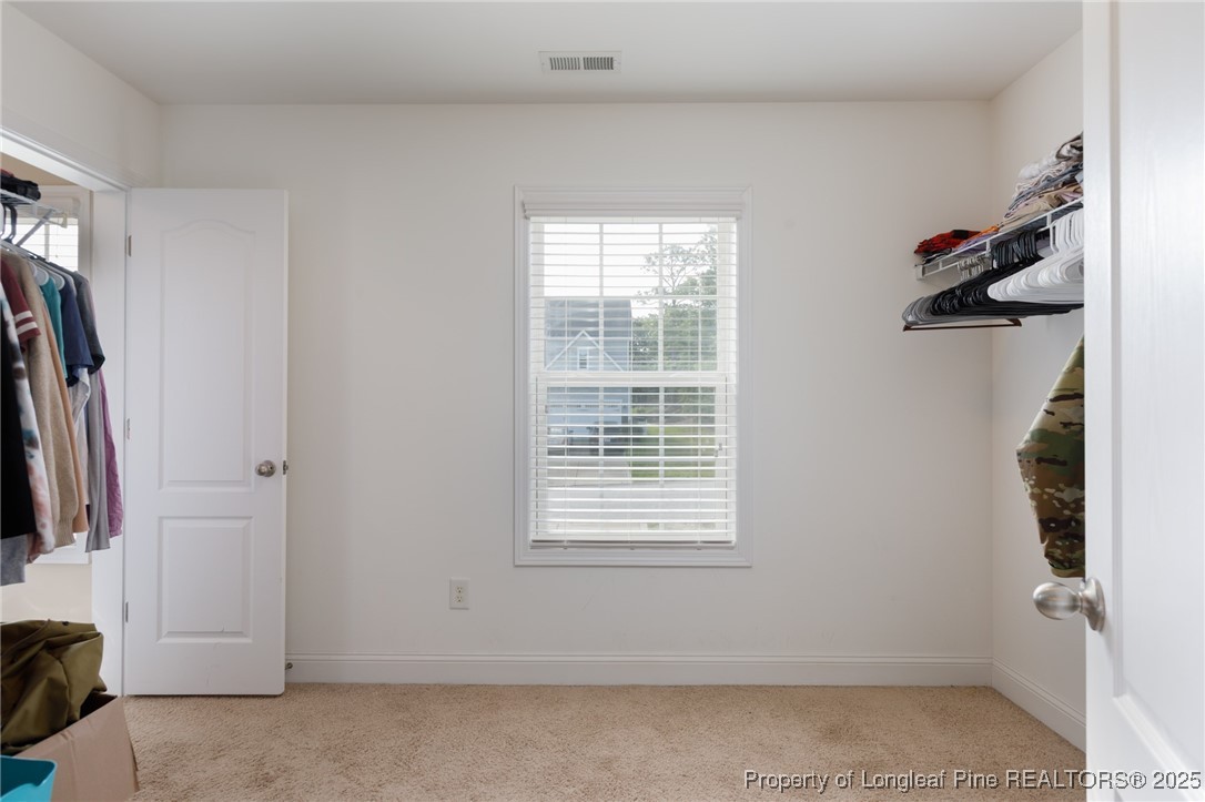 40 Cherry Hill Drive Lillington, NC 27546 - Photo 19 of 30 a view of walk in closet with clothes and shoes