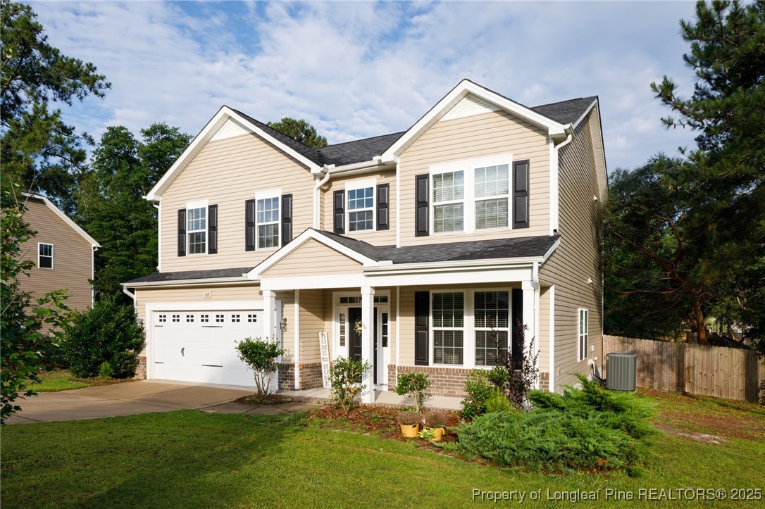 40 Cherry Hill Drive Lillington, NC 27546 - Photo 2 of 30 a view of a white house with a yard and plants