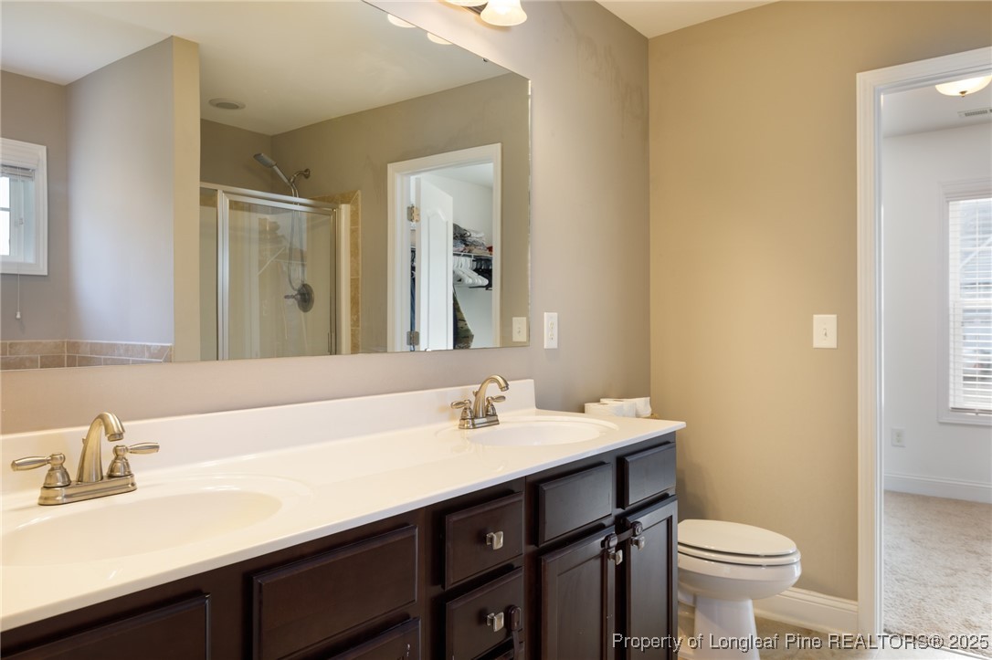 40 Cherry Hill Drive Lillington, NC 27546 - Photo 21 of 30 a bathroom with a sink and a toilet