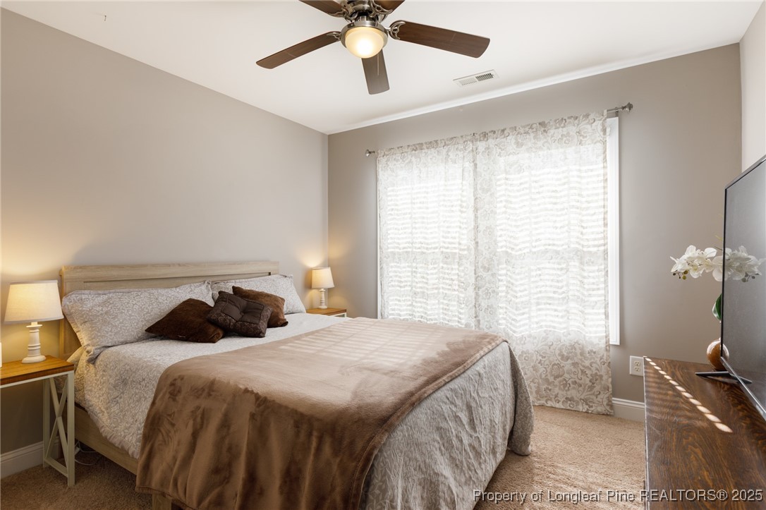 40 Cherry Hill Drive Lillington, NC 27546 - Photo 24 of 30 a bedroom with a bed and window