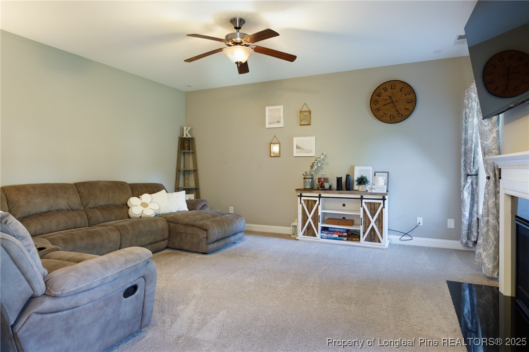 40 Cherry Hill Drive Lillington, NC 27546 - Photo 25 of 30 a living room with furniture and a table
