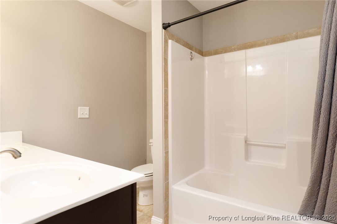 40 Cherry Hill Drive Lillington, NC 27546 - Photo 27 of 30 a bathroom with a bathtub and a sink