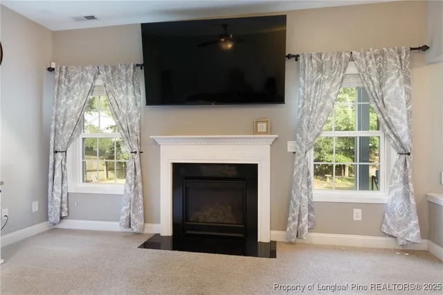a living room with a fireplace and a flat screen tv