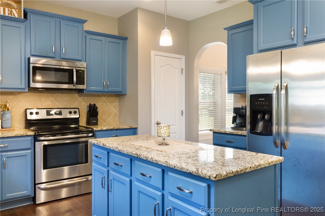 40 Cherry Hill Drive Lillington, NC 27546 - Photo 6 of 30 a kitchen with stainless steel appliances granite countertop a stove a sink and a microwave
