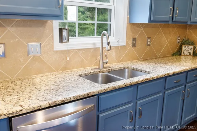 a kitchen with a sink a counter top and a window