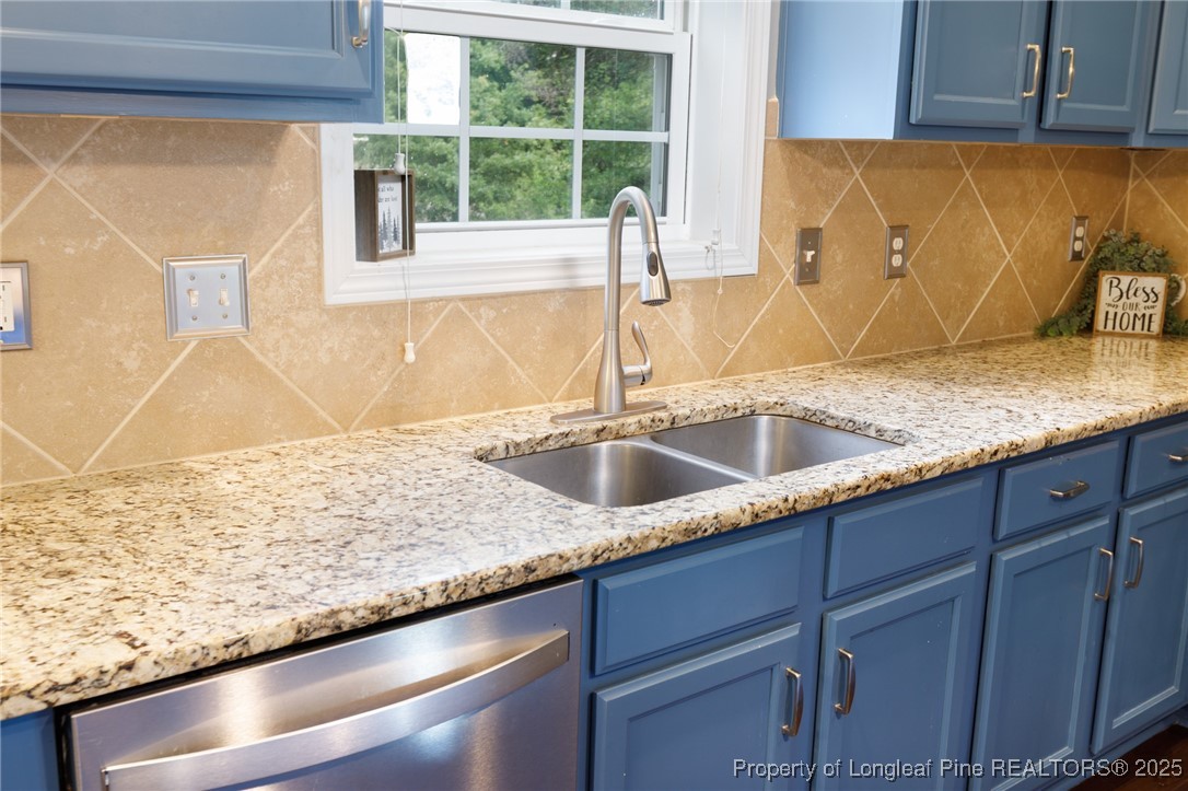 40 Cherry Hill Drive Lillington, NC 27546 - Photo 7 of 30 a kitchen with a sink a counter top and a window