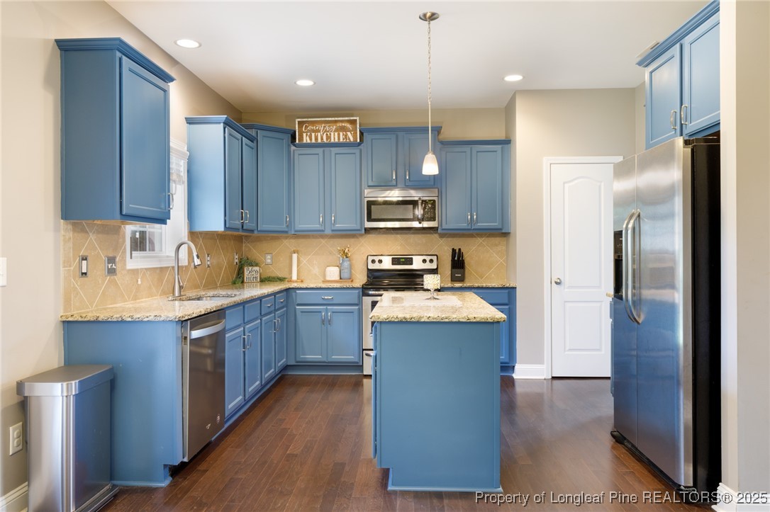 40 Cherry Hill Drive Lillington, NC 27546 - Photo 9 of 30 a kitchen with stainless steel appliances granite countertop a refrigerator a sink dishwasher a stove and a oven with wooden floor