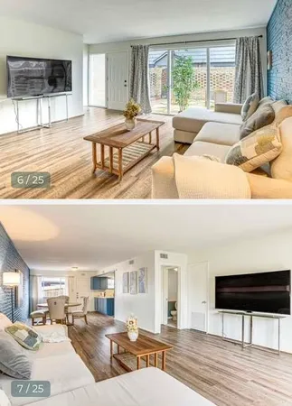 a living room with furniture and a wooden floor