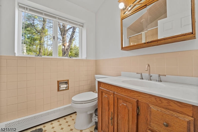 36 Dunnell Road Maplewood, NJ 07040 - Photo 12 of 35 a bathroom with a granite countertop toilet sink and mirror