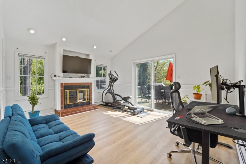 36 Dunnell Road Maplewood, NJ 07040 - Photo 14 of 35 a living room with furniture a fireplace and a flat screen tv