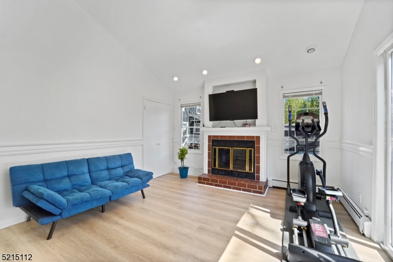 36 Dunnell Road Maplewood, NJ 07040 - Photo 15 of 35 a living room with furniture a fireplace and a flat screen tv
