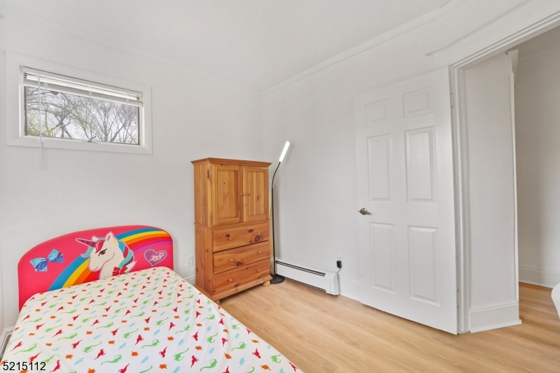 36 Dunnell Road Maplewood, NJ 07040 - Photo 23 of 35 a bedroom with a bed and wooden floor