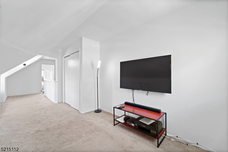 36 Dunnell Road Maplewood, NJ 07040 - Photo 29 of 35 a living room with furniture and a flat screen tv