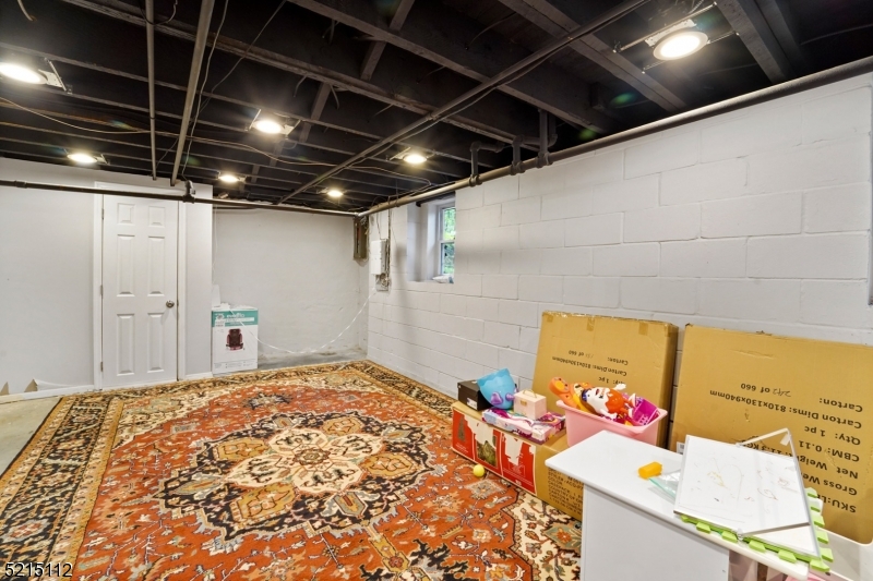 36 Dunnell Road Maplewood, NJ 07040 - Photo 31 of 35 a bedroom with a bed and a chandelier