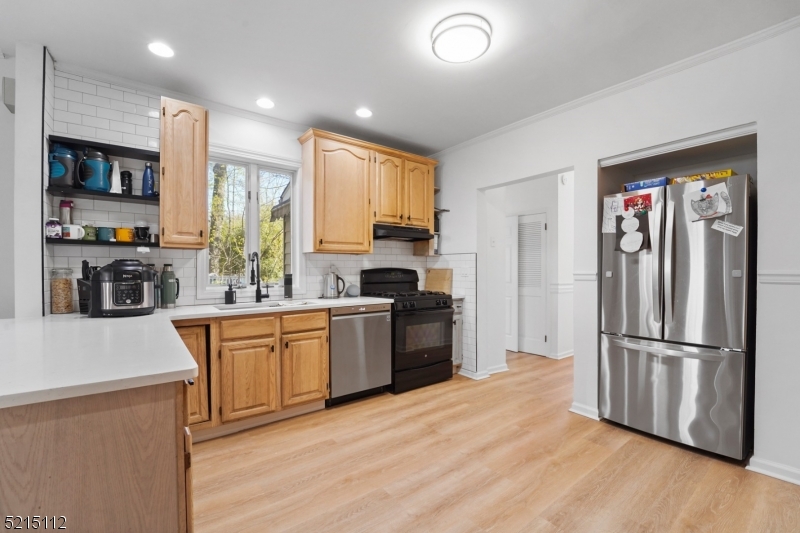 36 Dunnell Road Maplewood, NJ 07040 - Photo 9 of 35 a kitchen with stainless steel appliances granite countertop a refrigerator stove top oven and sink