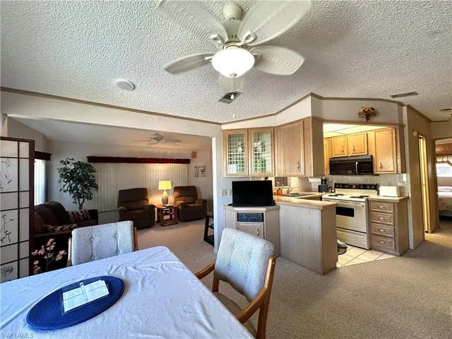 a living room with furniture kitchen view and a stove