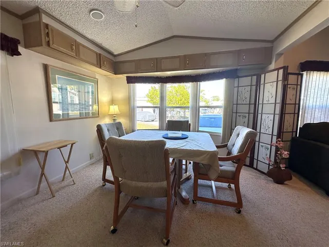 a view of a dining room with furniture a chandelier and wooden floor