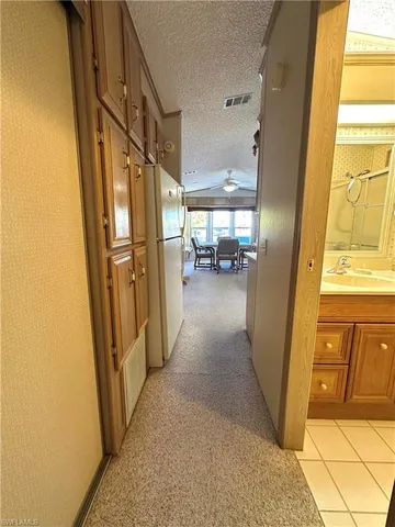a view of a hallway with furniture and floor to ceiling window