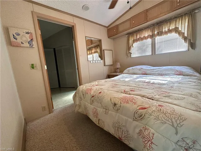 a spacious bedroom with a bed and a window