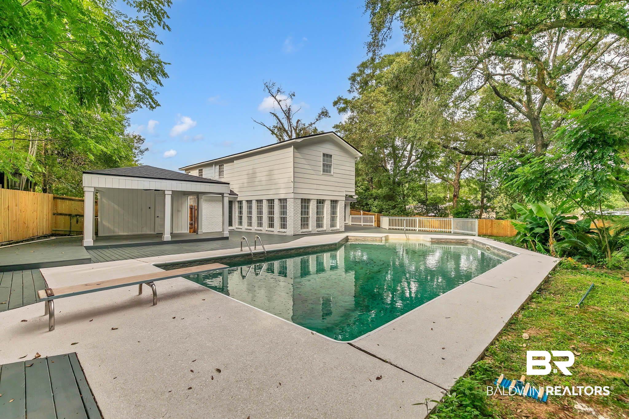 4705 Sherry Court Mobile, AL 36693 - Photo 62 of 100 View of swimming pool featuring a fenced backyard, a patio, and a diving board