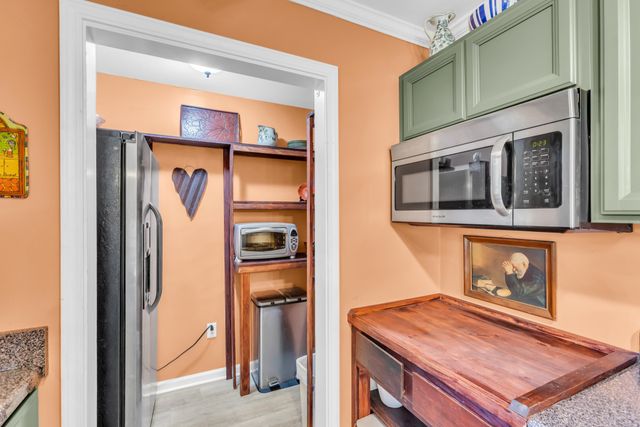 a kitchen with stainless steel appliances granite countertop a sink a stove top oven a granite counter space and cabinets