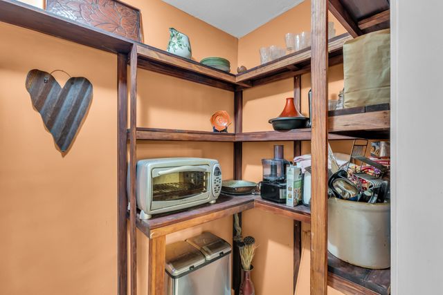 a spacious bedroom with a bed and large windows