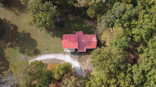 a backyard of a house with a yard and outdoor seating