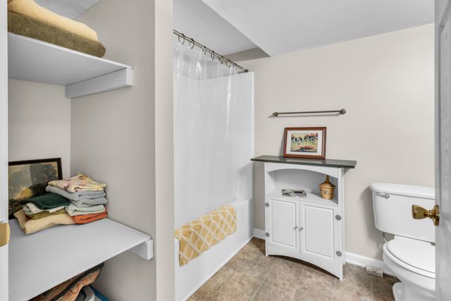 a bed room with a bed and a chandelier