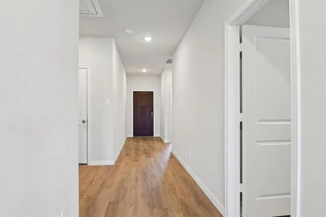 an empty room with closet and mirror
