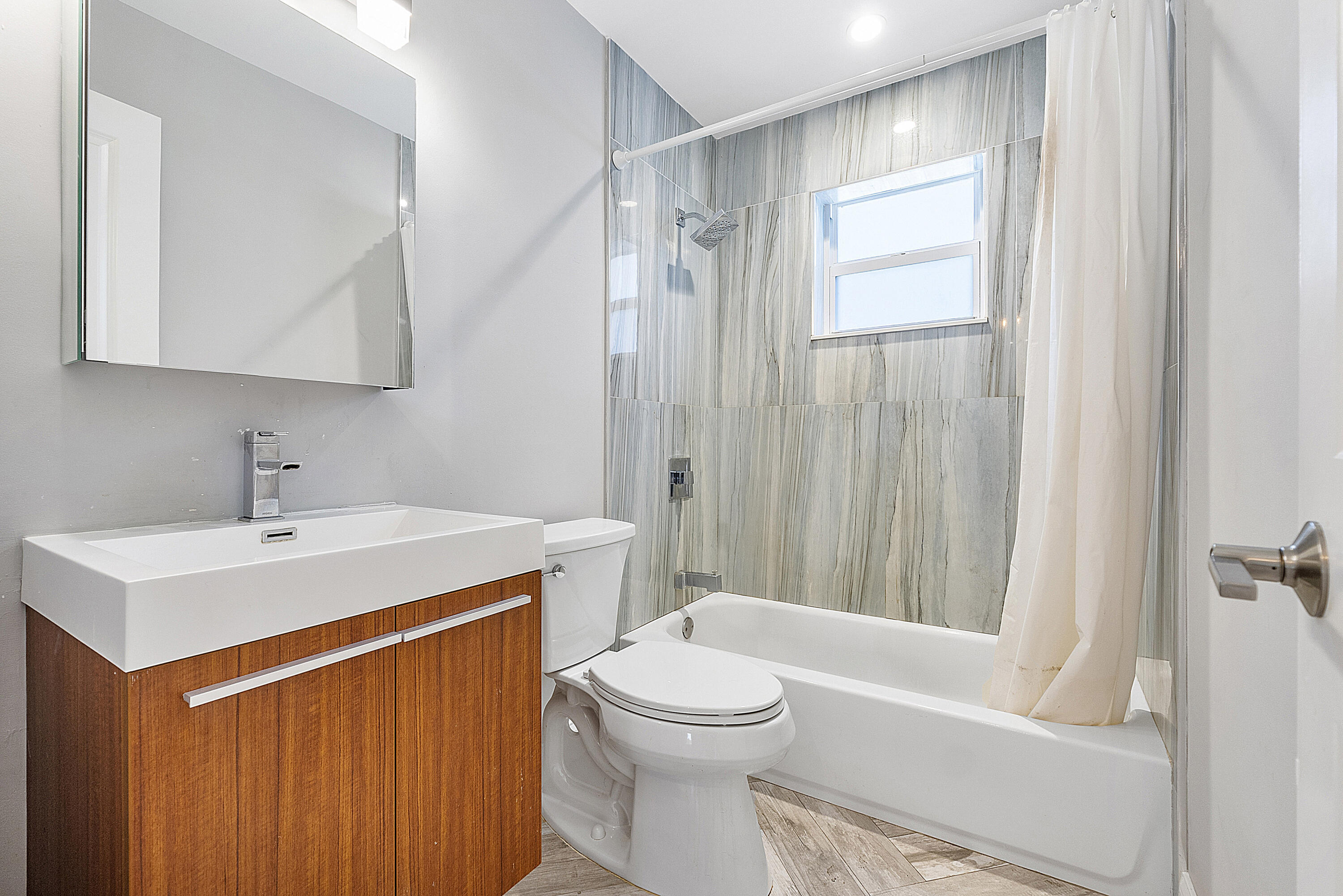 4064 Northwest 2nd Court Boca Raton, FL 33431 - Photo 23 of 57 a bathroom with a sink a toilet and shower