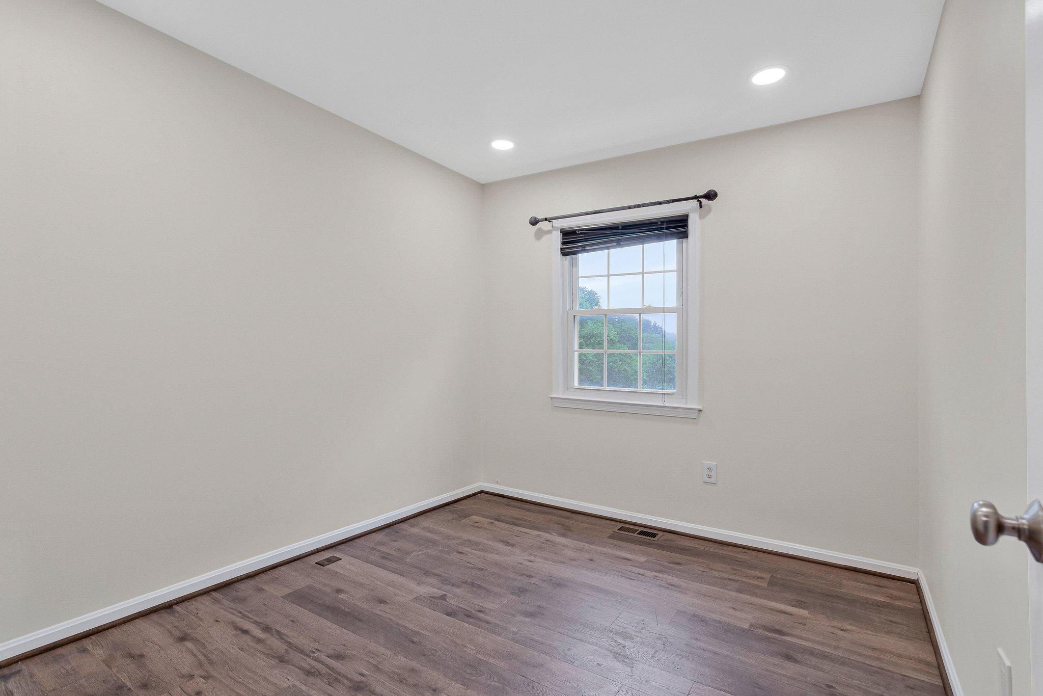 1675 Ridgely Court, Unit 182 Crofton, MD 21114 - Photo 39 of 47 an empty room with wooden floor and windows