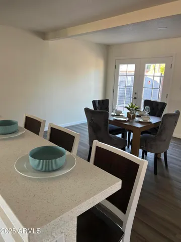 a dining room with furniture and wooden floor