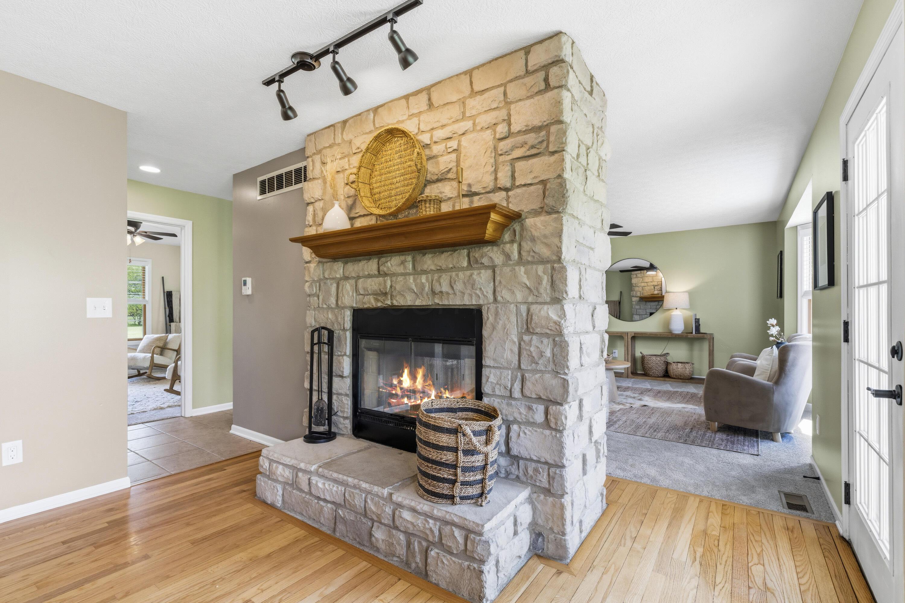 8507 Benner Road Johnstown, OH 43031 - Photo 13 of 69 Double-sided fireplace with one side in Family Room and other side in Kitchen/Dining Room area!