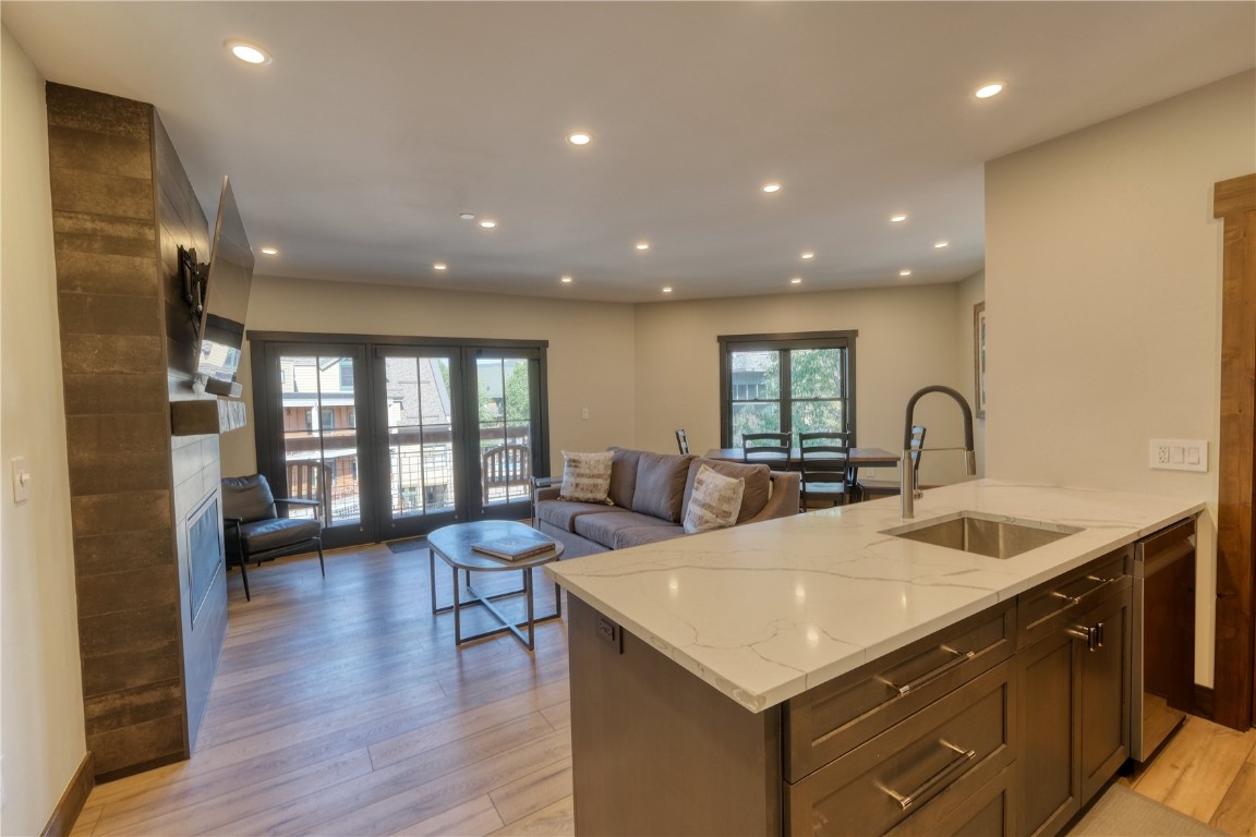 195 River Run Road, Unit 8013 Keystone, CO 80435 - Photo 2 of 38 Kitchen featuring tasteful backsplash, lvp flooring, quartz counters, stainless steel appliances