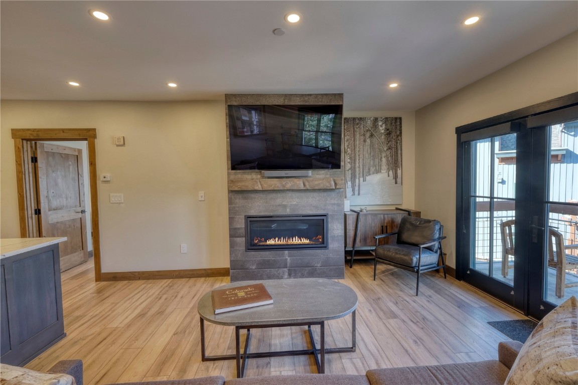 195 River Run Road, Unit 8013 Keystone, CO 80435 - Photo 7 of 38 Living room with a tile fireplace and lvp flooring