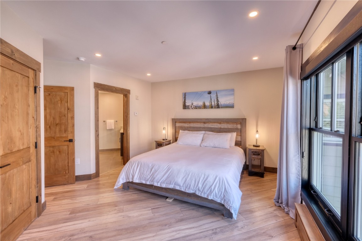 195 River Run Road, Unit 8013 Keystone, CO 80435 - Photo 9 of 38 Bedroom featuring ensuite bath, lots of natural light, and lvp flooring