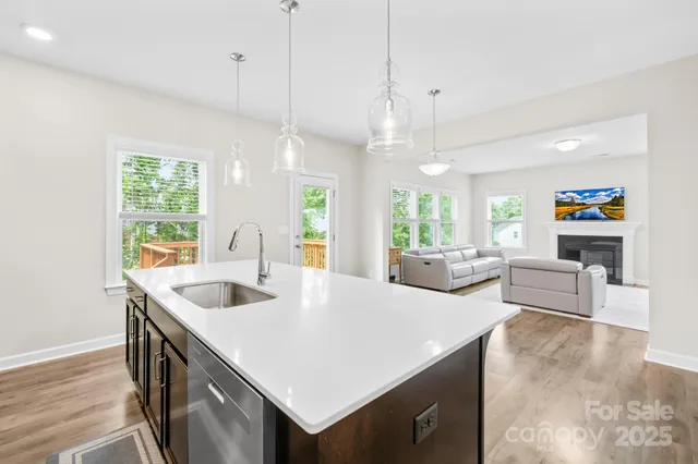 a large white kitchen with a large island