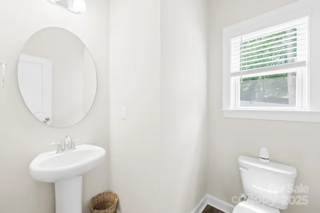 a bathroom with a sink a mirror and a toilet